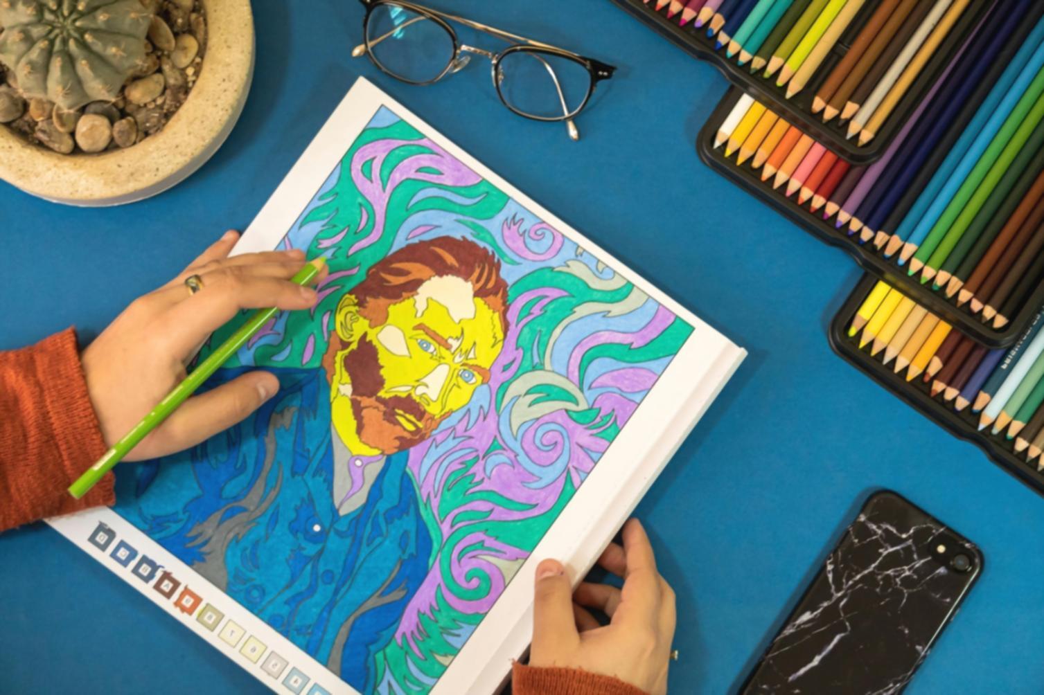 Portrait of a drawing student reviewing their sketchbook work